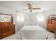 This bedroom has great light, a ceiling fan, and vintage dressers at 3210 Acacia St, Lutz, FL 33558