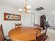 Dining room features a wooden table, chandelier, and classic decor at 3210 Acacia St, Lutz, FL 33558