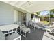 Enclosed porch with comfortable seating and a table, perfect for relaxing at 3210 Acacia St, Lutz, FL 33558
