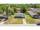 An aerial view of a cozy single-Gathering home with a well-maintained front yard at 3210 Acacia St, Lutz, FL 33558