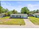 Charming single-story home with a well-maintained lawn and a classic brick-lined driveway at 3210 Acacia St, Lutz, FL 33558