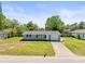 Charming single-story home featuring a well-manicured lawn and a driveway leading to an attached garage at 3210 Acacia St, Lutz, FL 33558