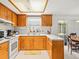 Classic kitchen design with wood cabinets, breakfast bar, and an open dining area at 3210 Acacia St, Lutz, FL 33558