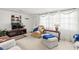 Comfortable living room featuring a TV, built-in shelves, and bright natural lighting at 3210 Acacia St, Lutz, FL 33558