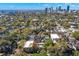 Aerial view of neighborhood featuring mature landscaping, multiple houses, and a city skyline at 346 16Th Ne Ave, St Petersburg, FL 33704