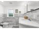 Bright bathroom boasts double sinks with marble countertops, wall tiles, and decorative accents at 346 16Th Ne Ave, St Petersburg, FL 33704