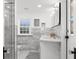 Elegant bathroom featuring a glass-enclosed shower, double sinks, and sophisticated marble tile and mosaic tile floor at 346 16Th Ne Ave, St Petersburg, FL 33704