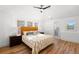 Sun-filled bedroom with wood floors, stylish ceiling fan, and views to the adjacent bath at 346 16Th Ne Ave, St Petersburg, FL 33704