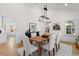 Dining room features a rustic table, modern chandelier, and views into other living spaces at 346 16Th Ne Ave, St Petersburg, FL 33704