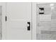 Stylish white doorknob and black hardware on a white paneled door at 346 16Th Ne Ave, St Petersburg, FL 33704
