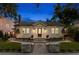Charming home with landscaped walkway, garden, and inviting front porch lights at twilight at 346 16Th Ne Ave, St Petersburg, FL 33704