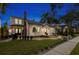Exterior view of a two-story home at night with inviting landscape lighting at 346 16Th Ne Ave, St Petersburg, FL 33704