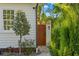 Side yard with a wooden gate and lush greenery, providing privacy and access at 346 16Th Ne Ave, St Petersburg, FL 33704