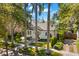 Exterior view of a charming home with well-manicured landscaping, palm trees and mature trees at 346 16Th Ne Ave, St Petersburg, FL 33704