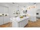Bright, all-white kitchen with marble countertops, herringbone floors, and modern appliances at 346 16Th Ne Ave, St Petersburg, FL 33704