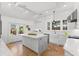 Spacious kitchen with a marble island, white cabinets, herringbone floors, and stainless steel appliances at 346 16Th Ne Ave, St Petersburg, FL 33704