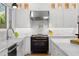 Bright white kitchen with stainless steel appliances and herringbone floor at 346 16Th Ne Ave, St Petersburg, FL 33704