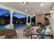 Inviting covered patio featuring ample seating, brick fireplace, and tranquil views of the sparkling pool at twilight at 346 16Th Ne Ave, St Petersburg, FL 33704