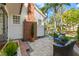 Back patio featuring wicker chairs with blue cushions and brick chimney, providing outdoor comfort at 346 16Th Ne Ave, St Petersburg, FL 33704