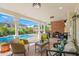 Covered outdoor patio with a brick fireplace, pool, and seating area at 346 16Th Ne Ave, St Petersburg, FL 33704