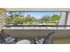 Balcony with comfortable seating and a scenic view of the parking and greenery at 36750 Us 19 N # 19212, Palm Harbor, FL 34684
