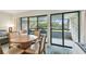 Interior view showcasing a table with chairs, a balcony with seating, and views of the building's exterior at 36750 Us 19 N # 19212, Palm Harbor, FL 34684