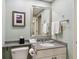 Well-lit bathroom with a granite countertop, framed mirror, and tile flooring at 36750 Us 19 N # 19212, Palm Harbor, FL 34684