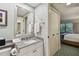 Well-lit bathroom with a granite countertop and access to bedroom with large windows at 36750 Us 19 N # 19212, Palm Harbor, FL 34684