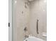 The tiled bathtub and shower area includes a shower head and hand bar for accessibility at 36750 Us 19 N # 19212, Palm Harbor, FL 34684