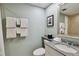 Well-lit bathroom with a granite countertop, framed mirror, and shower with white towels at 36750 Us 19 N # 19212, Palm Harbor, FL 34684
