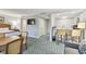 Cozy suite featuring a kitchenette, television, and a comfy bed, all adorned with a stylish blue patterned carpet at 36750 Us 19 N # 19212, Palm Harbor, FL 34684