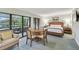 Comfortable bedroom featuring a quaint dining area, a cozy armchair, and an inviting outdoor balcony at 36750 Us 19 N # 19212, Palm Harbor, FL 34684