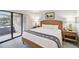 A calming bedroom offering a comfortable bed, nightstands, and balcony access for fresh air and views at 36750 Us 19 N # 19212, Palm Harbor, FL 34684