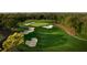 Expansive golf course featuring multiple sand traps, lush fairways, and mature trees at 36750 Us 19 N # 19212, Palm Harbor, FL 34684