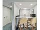 Compact kitchenette with bar seating, modern amenities, and ample storage space at 36750 Us 19 N # 19212, Palm Harbor, FL 34684