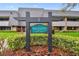 Exterior view of the Pine Valley Lodge 19 sign surrounded by lush landscaping and building at 36750 Us 19 N # 19212, Palm Harbor, FL 34684