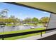 Scenic community parking lot view with lush landscaping and blue skies at 36750 Us 19 N # 19212, Palm Harbor, FL 34684