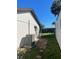 Exterior view of the home's backyard, featuring a compact outdoor AC unit at 3704 Haven Dr, New Port Richey, FL 34652