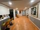 Open-concept living area featuring new paint, modern stools at the kitchen bar, and an inviting living room at 3704 Haven Dr, New Port Richey, FL 34652