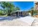 Beautifully landscaped backyard featuring a covered patio and lush greenery at 412 River S Blvd, Nokomis, FL 34275