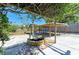 This backyard features a water feature, covered lounge area, and ample space for outdoor activities at 412 River S Blvd, Nokomis, FL 34275