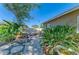 Charming backyard with rock features, lush greenery, brick, and a seating area, creating a serene retreat at 412 River S Blvd, Nokomis, FL 34275