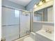This bathroom features a glass enclosed shower and a well-lit vanity with a white sink at 412 River S Blvd, Nokomis, FL 34275