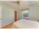 Comfortable bedroom with a ceiling fan, natural light, and wood flooring at 412 River S Blvd, Nokomis, FL 34275