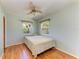 This comfortable bedroom features hardwood flooring and a ceiling fan at 412 River S Blvd, Nokomis, FL 34275