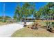 Exterior shot of home featuring a fenced entrance with gravel driveway and landscaped yard, ensuring privacy at 412 River S Blvd, Nokomis, FL 34275