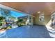 Patio area off the home featuring concrete flooring and lush greenery, creating an inviting outdoor space at 412 River S Blvd, Nokomis, FL 34275