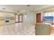 Bright kitchen with white appliances and tile flooring, leading to outdoor access at 412 River S Blvd, Nokomis, FL 34275