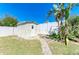 Backyard featuring a storage shed with stone pathway and privacy fence, ideal for organization at 412 River S Blvd, Nokomis, FL 34275