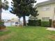Lush waterfront backyard features a boat dock, mature landscaping, and scenic views at 430 Larboard Way # 3, Clearwater Beach, FL 33767